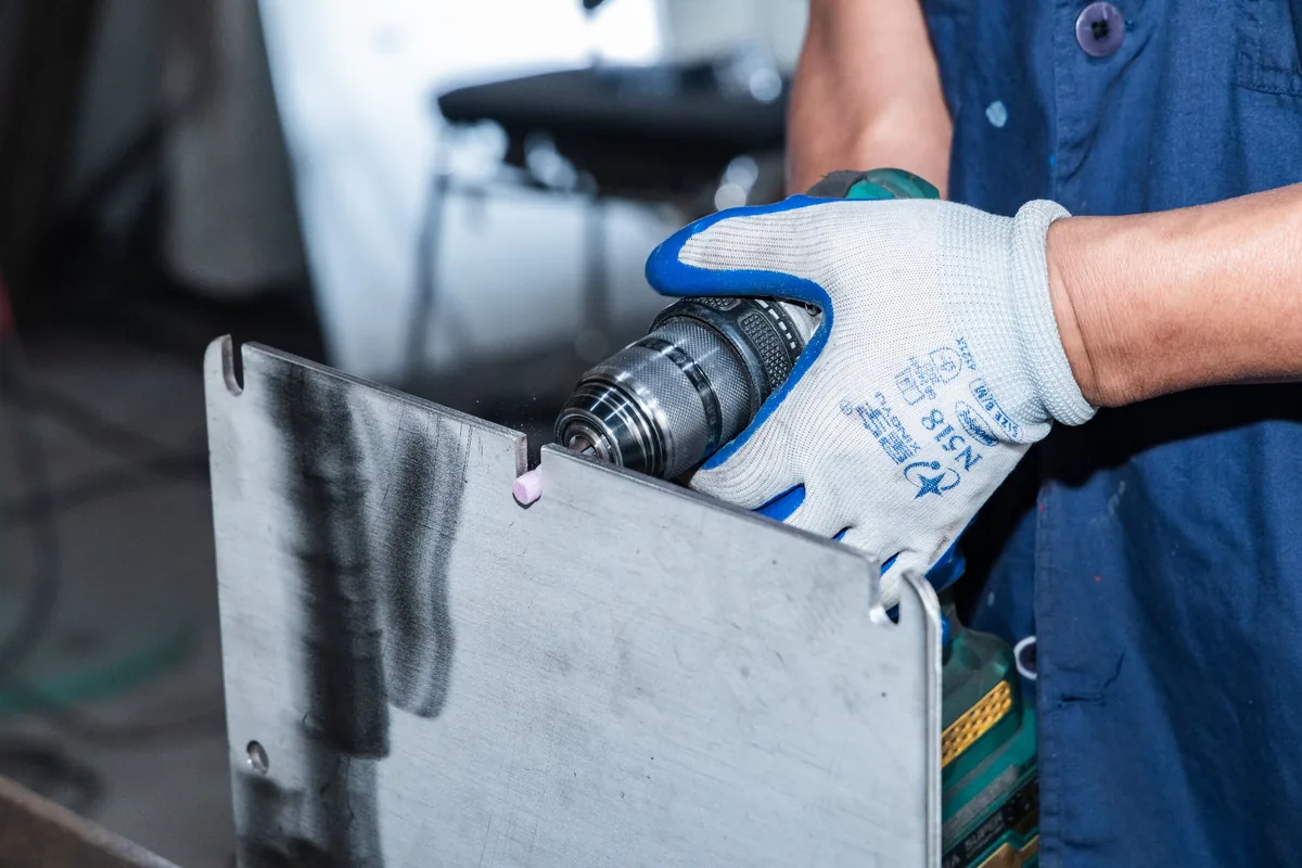 Precision drilling of a metal panel