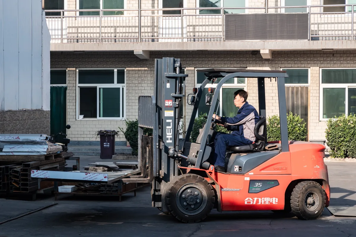 Forklift transporting metal components at the factory