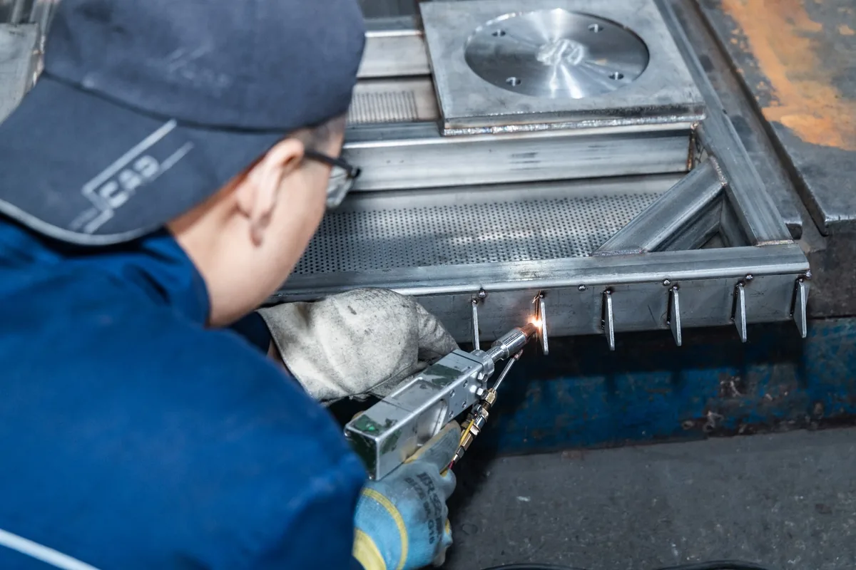 Worker welding a metal assembly