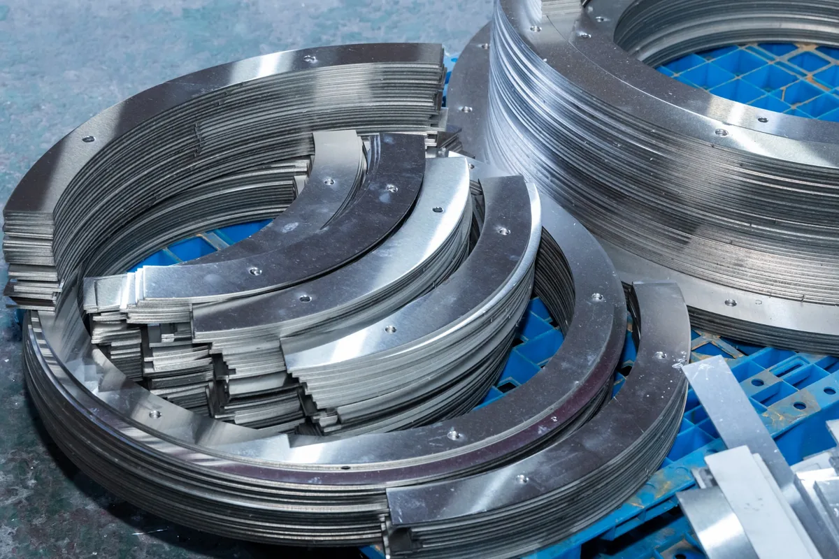 Stacks of curved finished metal components